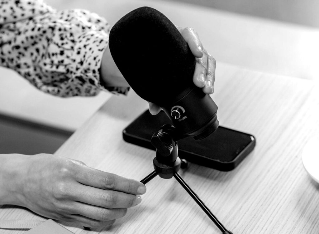 Hands adjusting a microphone